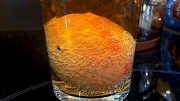 Egg covered in tiny bubbles in a glass of liquid
