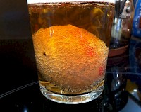 Egg covered in tiny bubbles in a glass of liquid